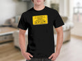 Black t-shirt with a yellow "Caution Fragile Handle With Care" graphic and icons.