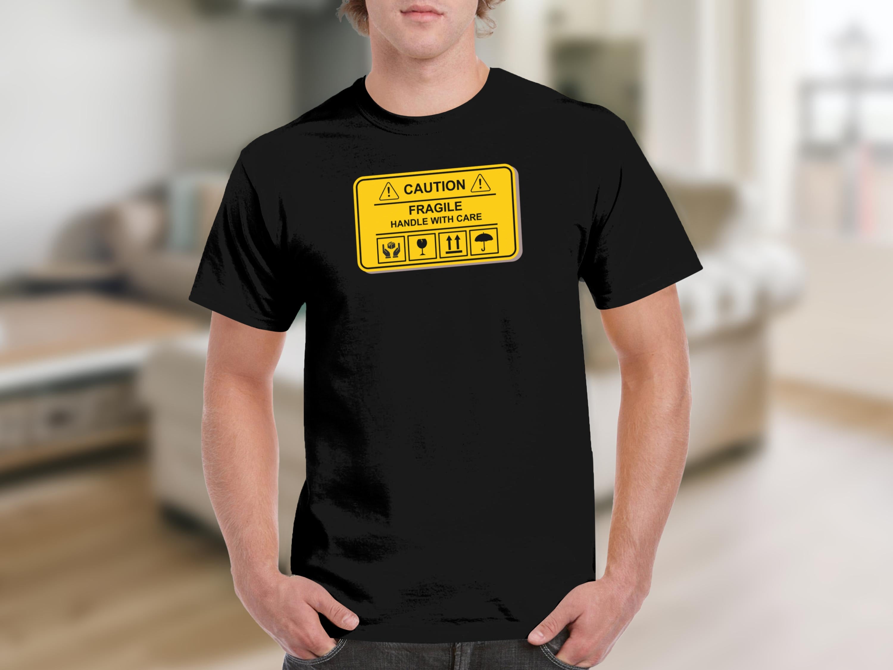 Black t-shirt with a yellow "Caution Fragile Handle With Care" graphic and icons.