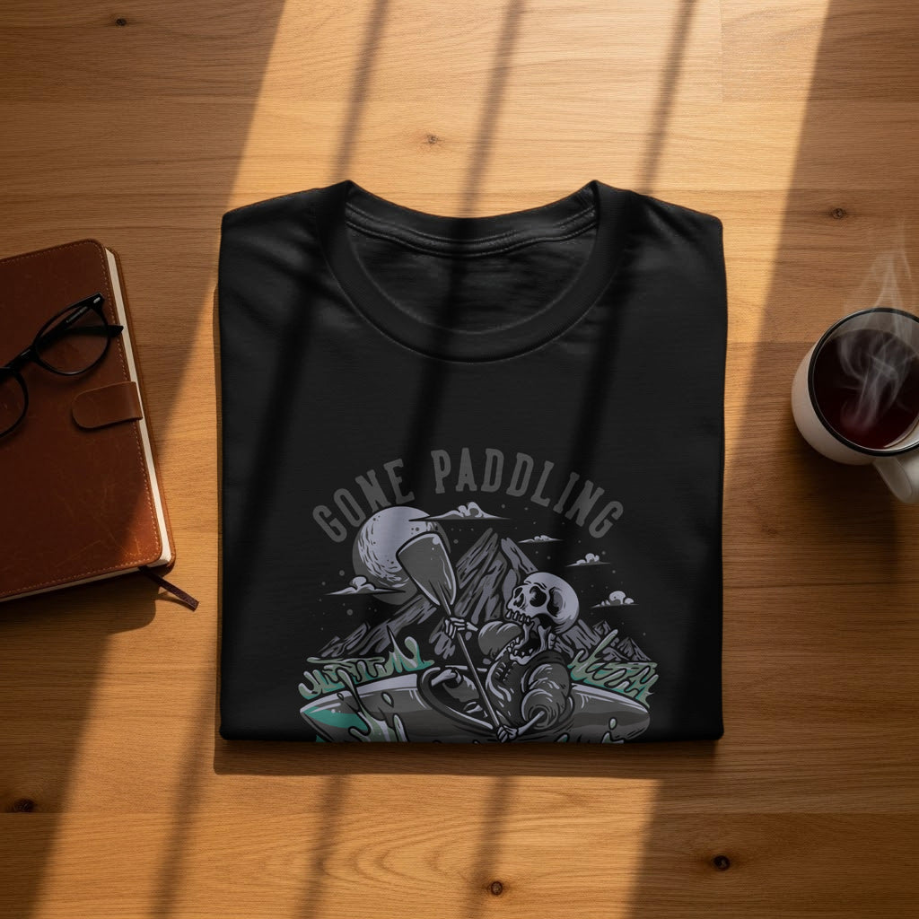 Black t-shirt with skeleton paddling graphic and "Gone Paddling" text.
