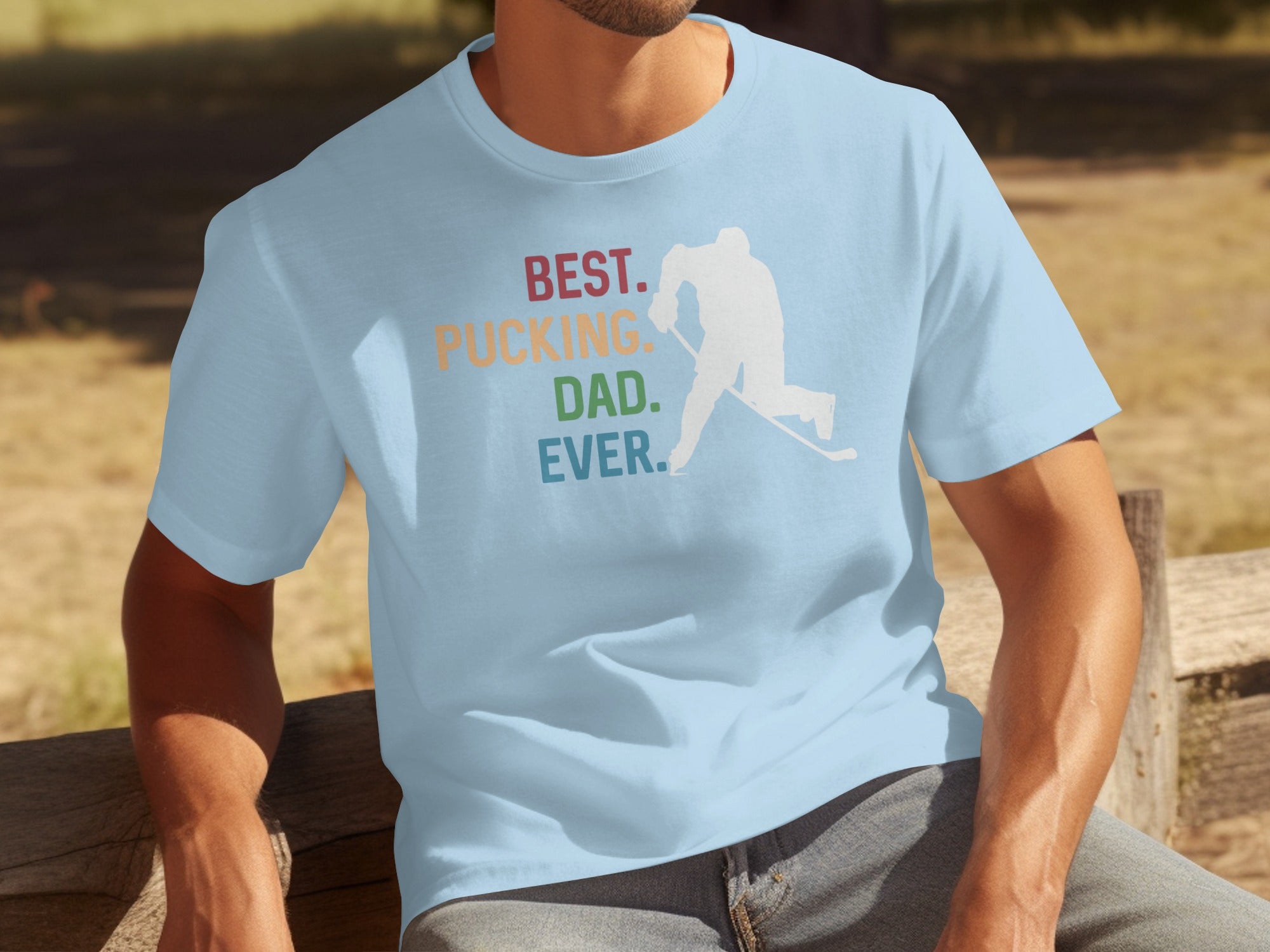 Light blue t-shirt with "BEST. PUCKING. DAD. EVER." and hockey player graphic.
