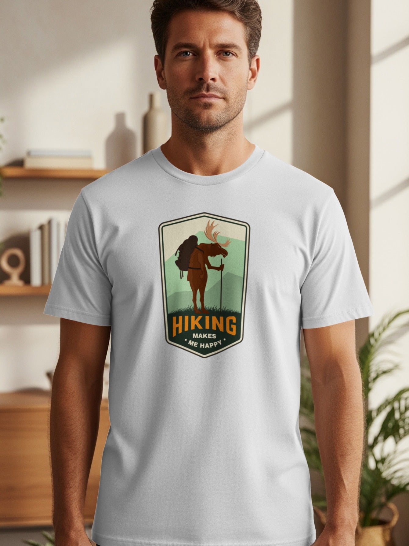 Gray t-shirt with a graphic of a moose hiking and the text "Hiking Makes Me Happy."