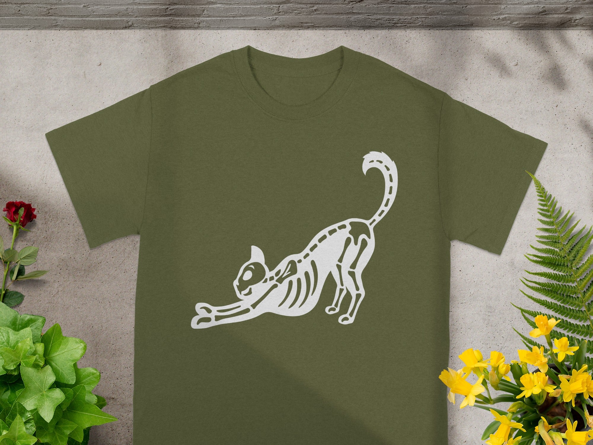 Olive green t-shirt with white skeleton cat graphic stretching