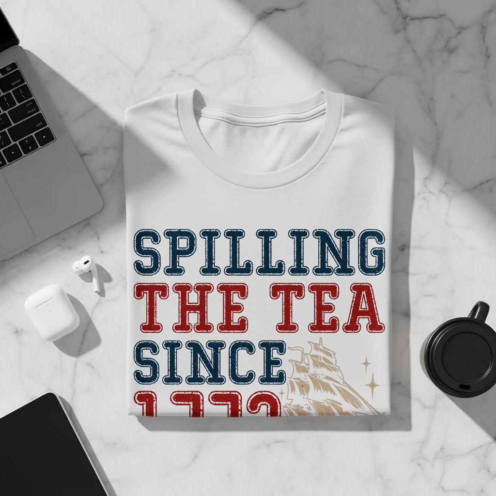 White t-shirt with text "SPILLING THE TEA SINCE 1773" and a ship.