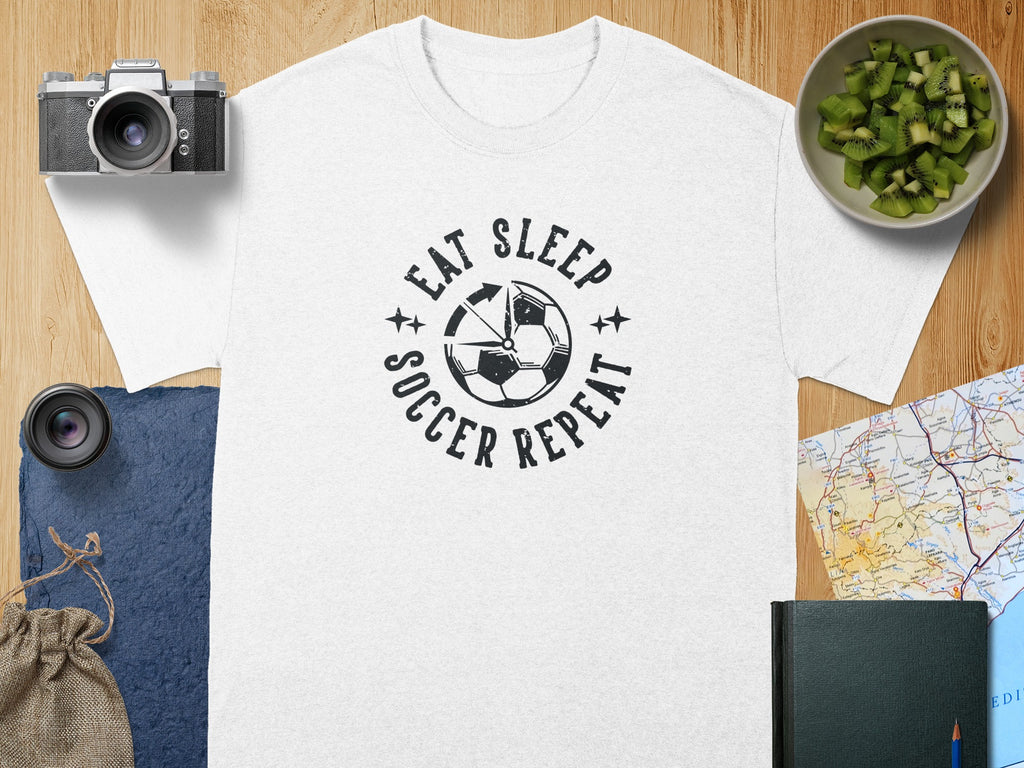 White t-shirt with "Eat Sleep Soccer Repeat" graphic and soccer ball design.