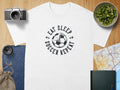 White t-shirt with "Eat Sleep Soccer Repeat" graphic and soccer ball design.