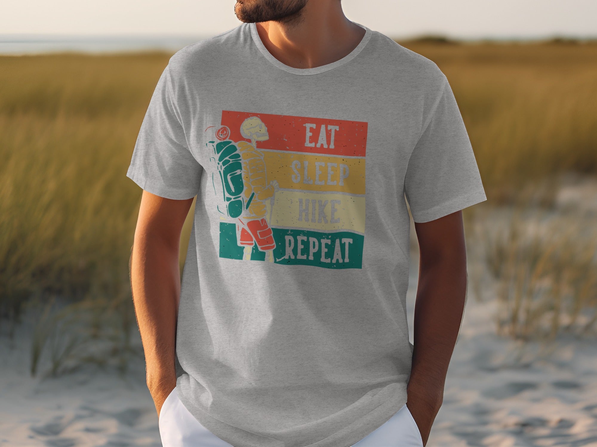 Gray t-shirt with graphic of skeleton hiker and text "Eat Sleep Hike Repeat".