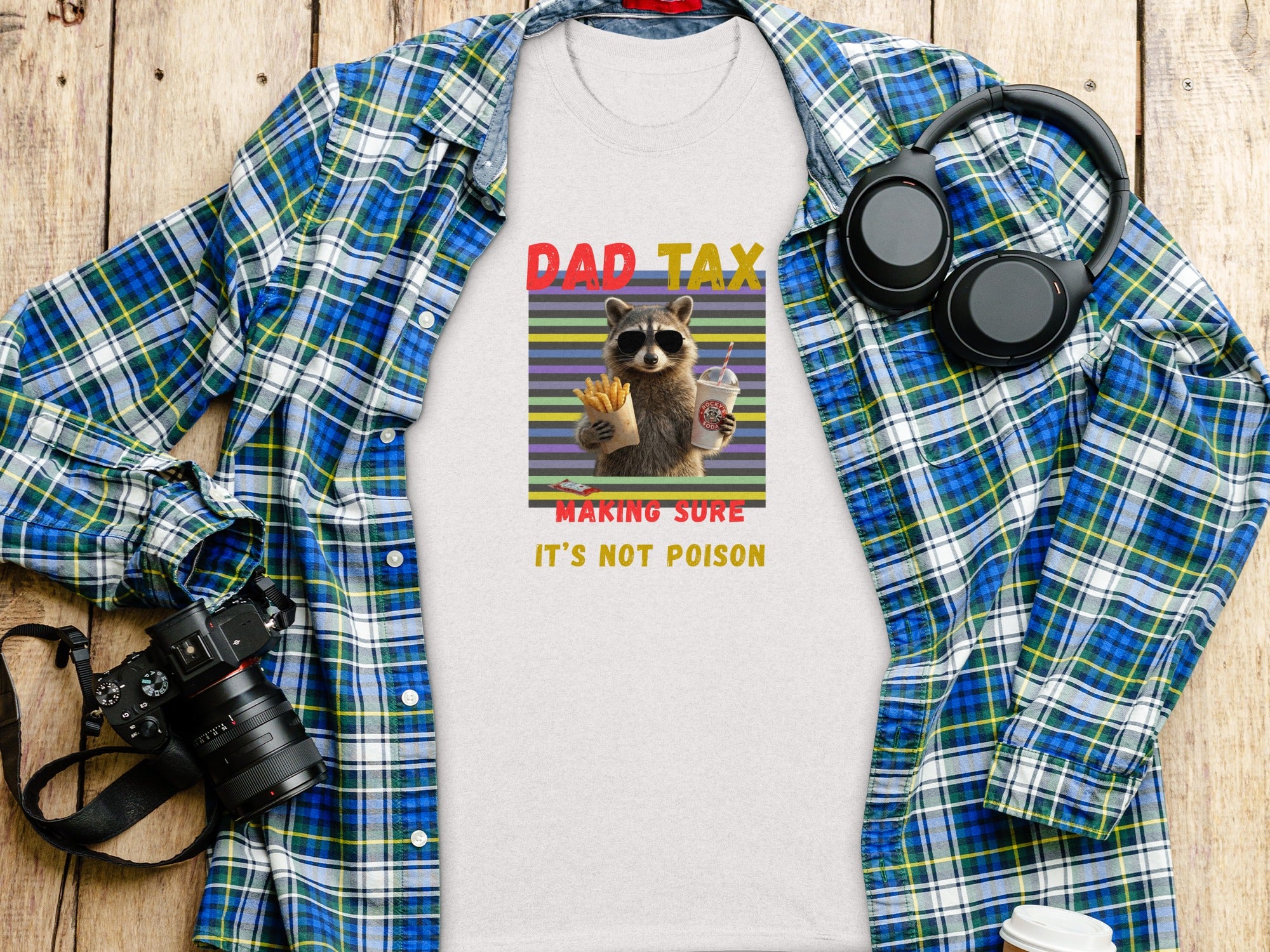 White t-shirt with "Dad Tax" graphic of raccoon eating fries and drinking soda.