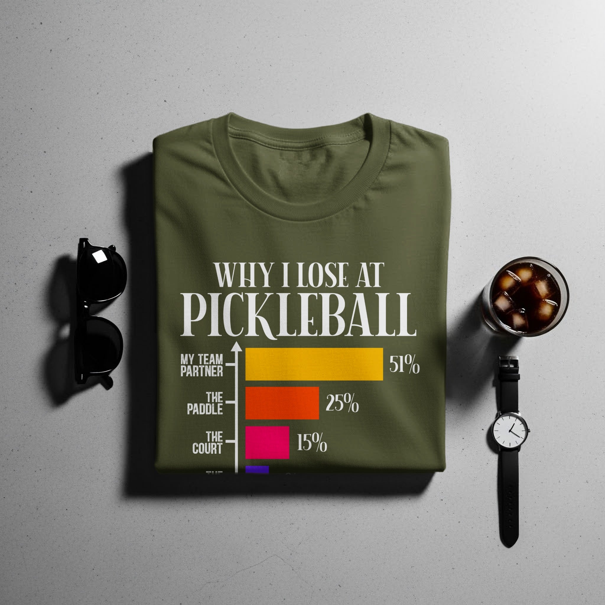 Green t-shirt with text "Why I Lose at Pickleball" and a bar chart.