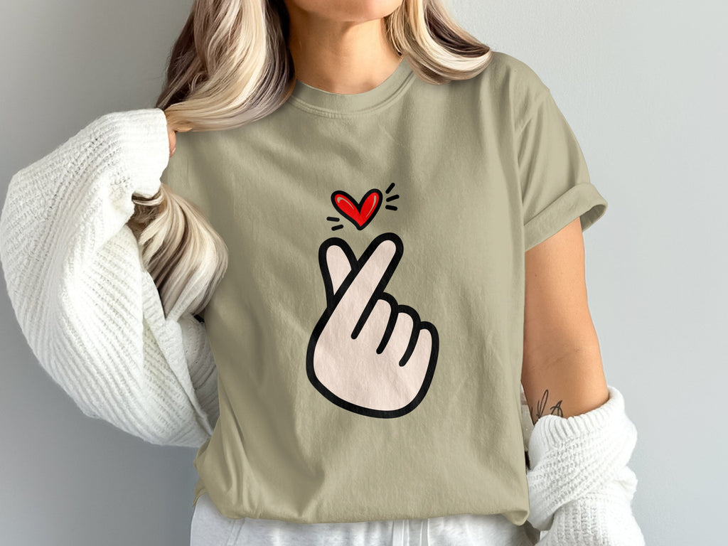 T-shirt with black outline drawing of a hand making a finger heart symbol and a red heart above.