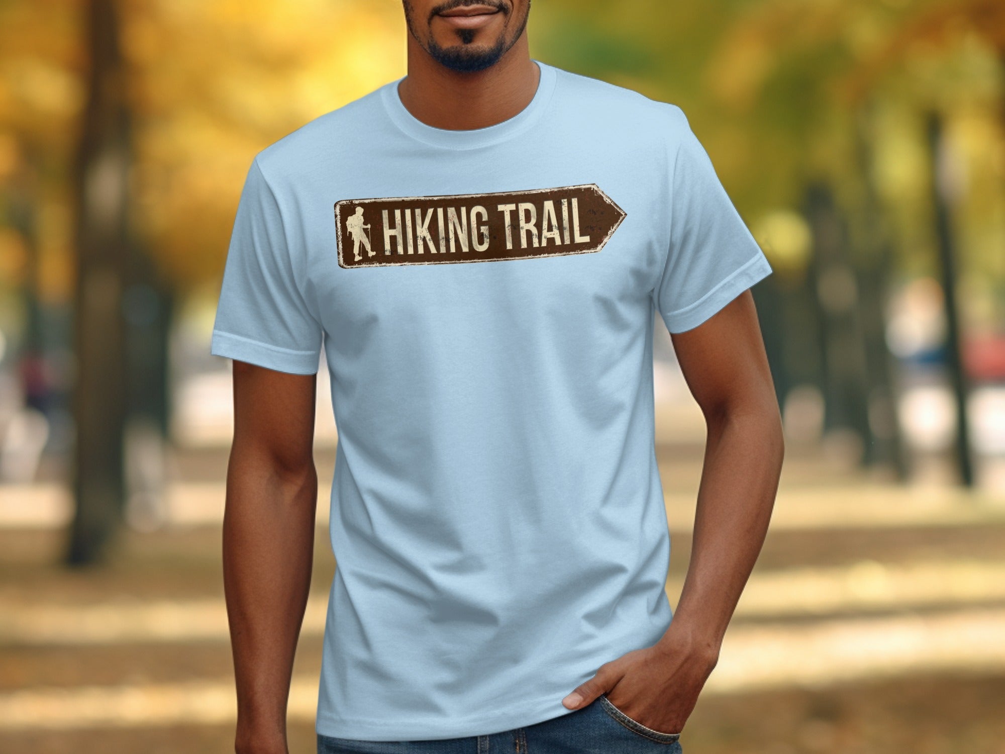 Light blue t-shirt with a brown hiking trail arrow sign graphic.
