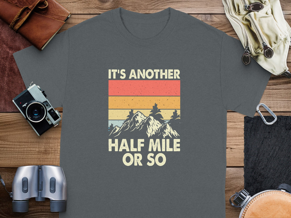 Dark grey t-shirt with retro mountain graphic: "It's another half mile or so".