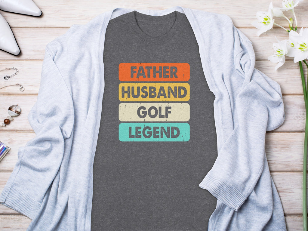 Dark gray t-shirt with text "Father Husband Golf Legend" in colored blocks.