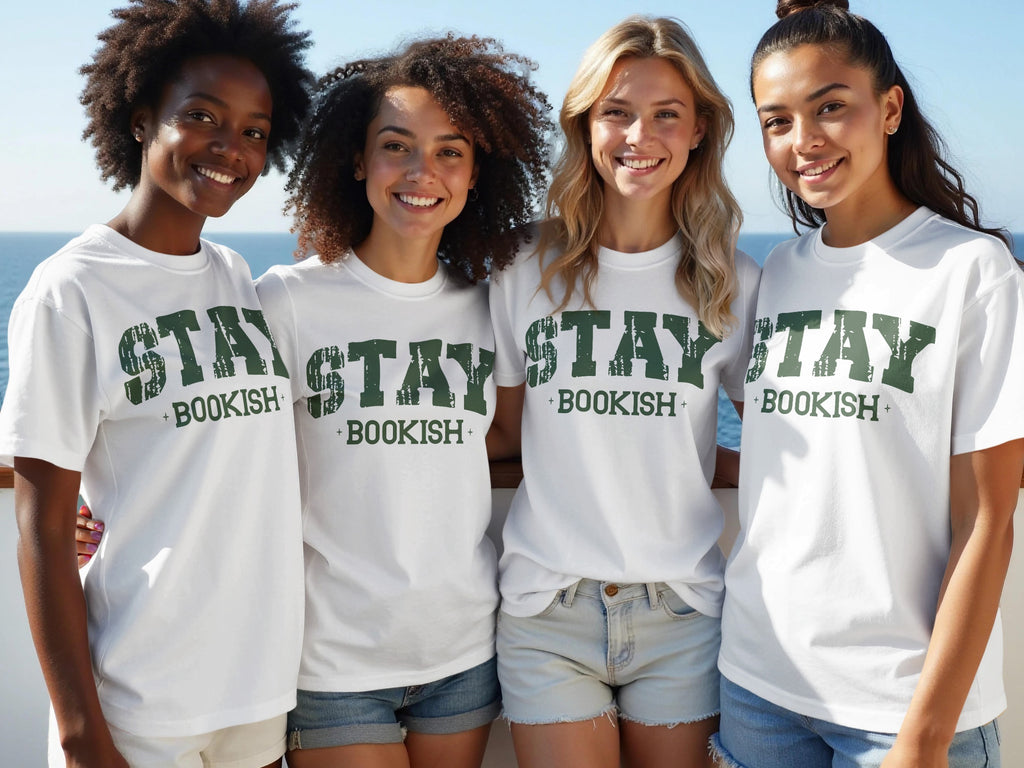 Four women wear white t-shirts printed with green "STAY BOOKISH" text.