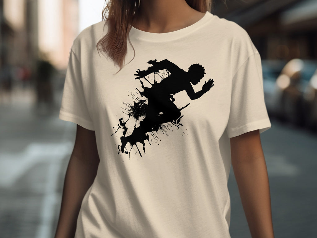 Cream t-shirt featuring a black silhouette of a runner amidst ink splatters.