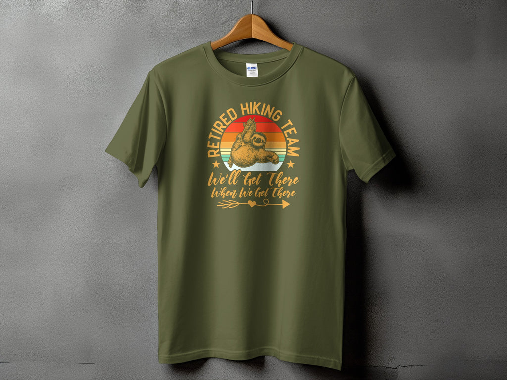 Olive green t-shirt with "Retired Hiking Team We'll Get There When We Get There" graphic.