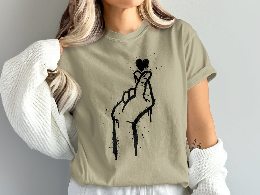 Khaki t-shirt with black graffiti-style hand and heart design.
