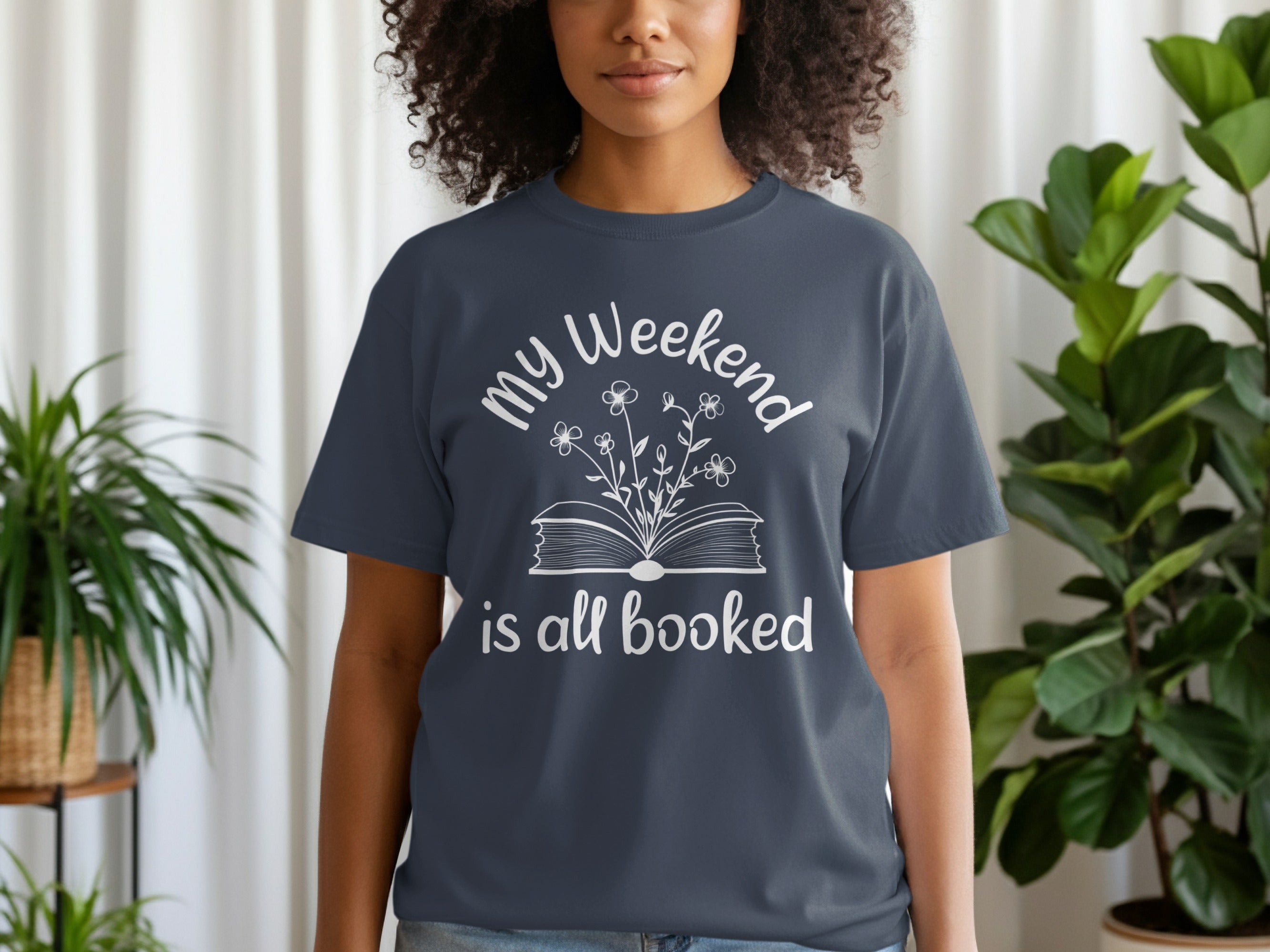 Dark blue t-shirt with white text and floral book graphic: "my Weekend is all booked".