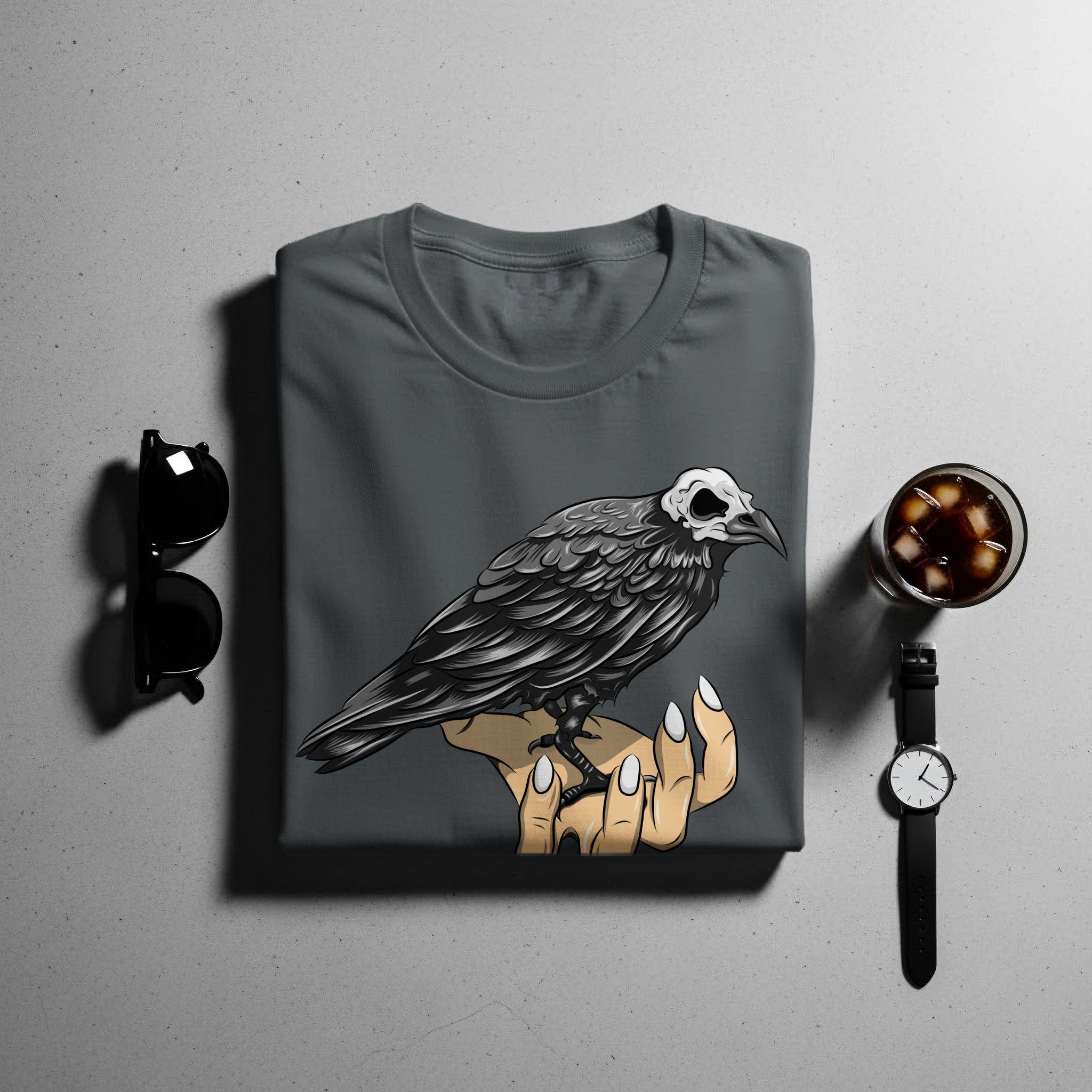 T-shirt with a skull-headed crow perched on a hand graphic.