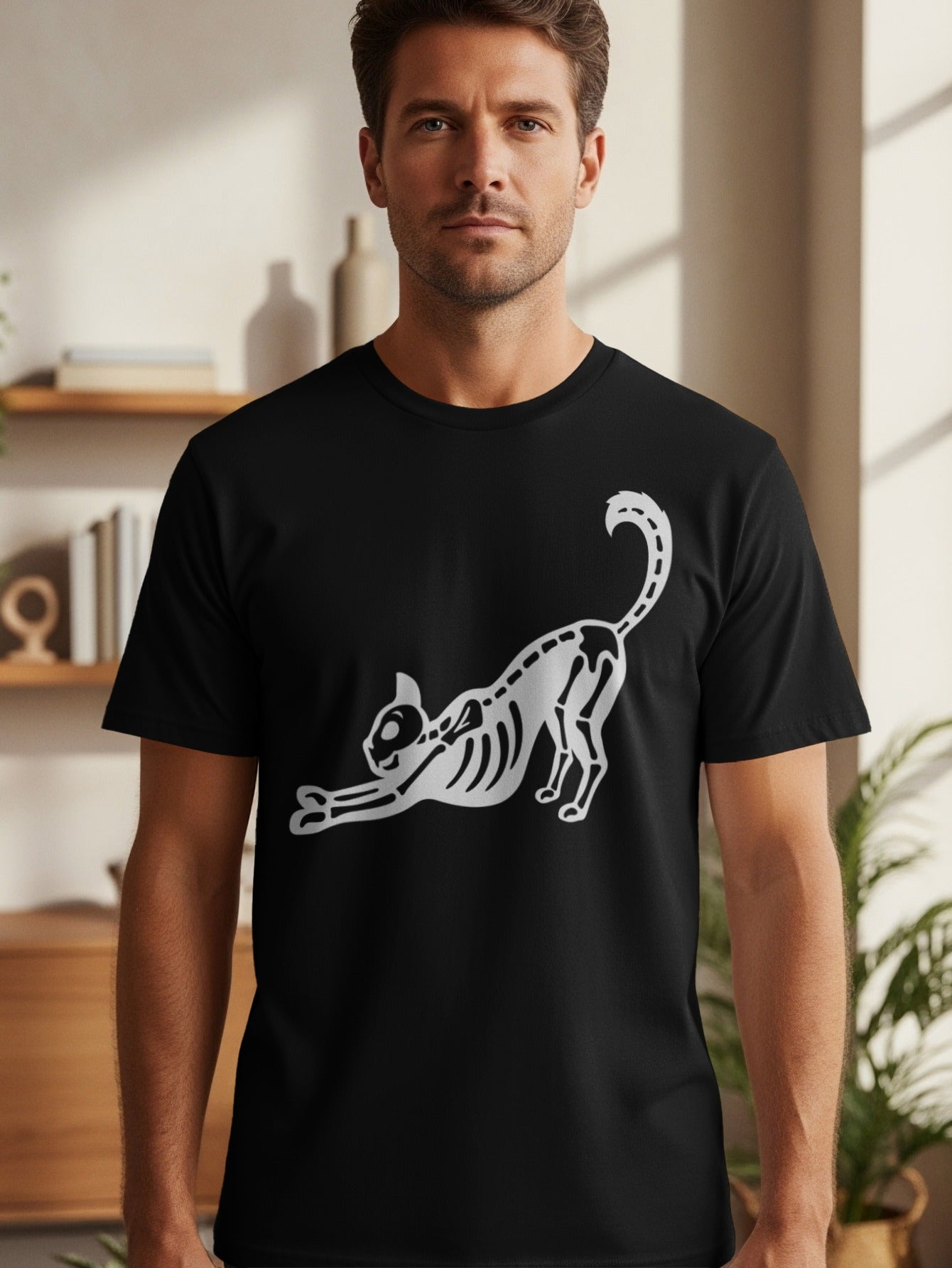 Black t-shirt with a white skeleton cat graphic stretching out.