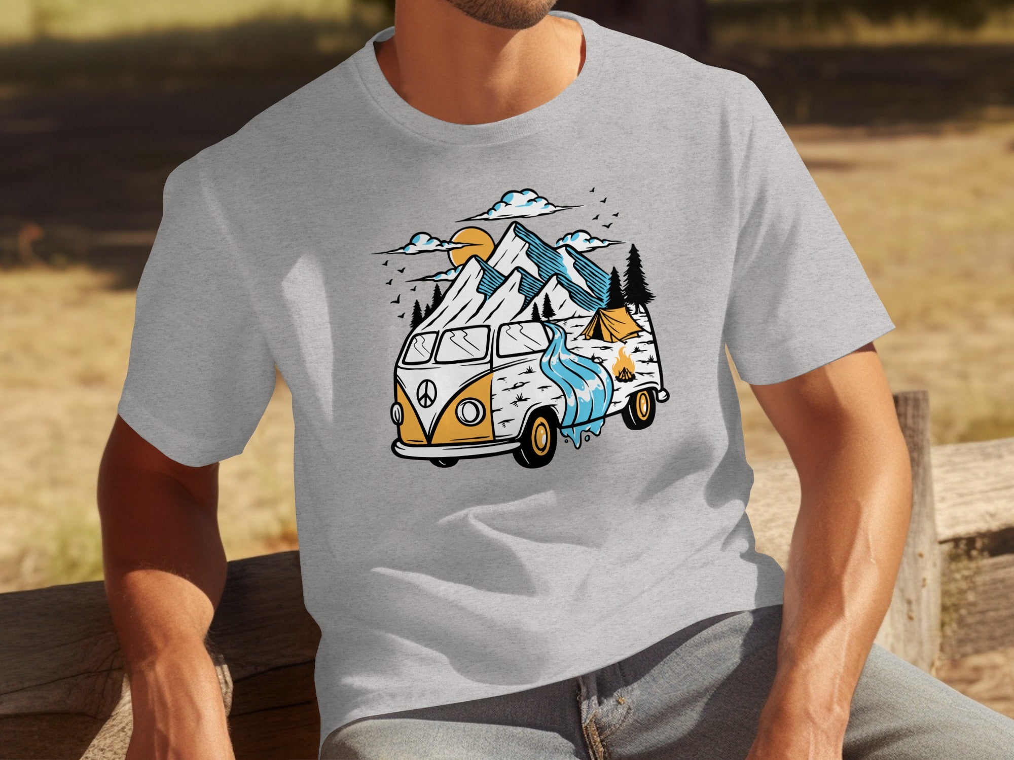 T-shirt graphic with vintage van, mountains, tent, campfire, and sun.