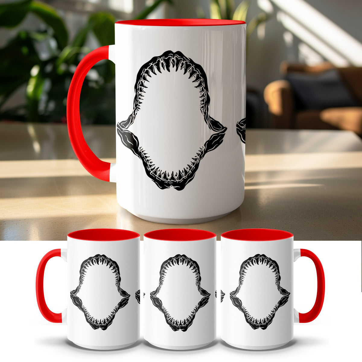 White mug with red handle and rim featuring a black shark jaw graphic.