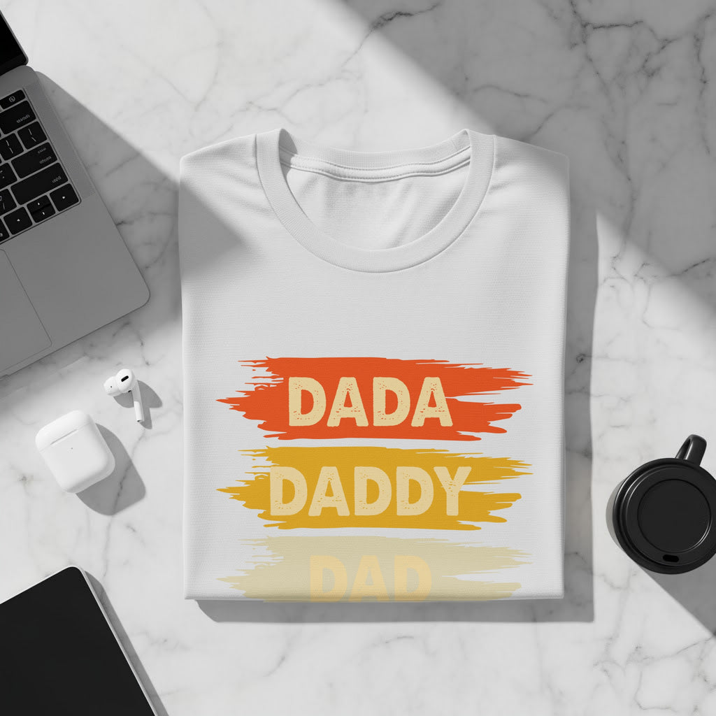 White t-shirt with "DADA" and "DADDY" in brushstroke text.