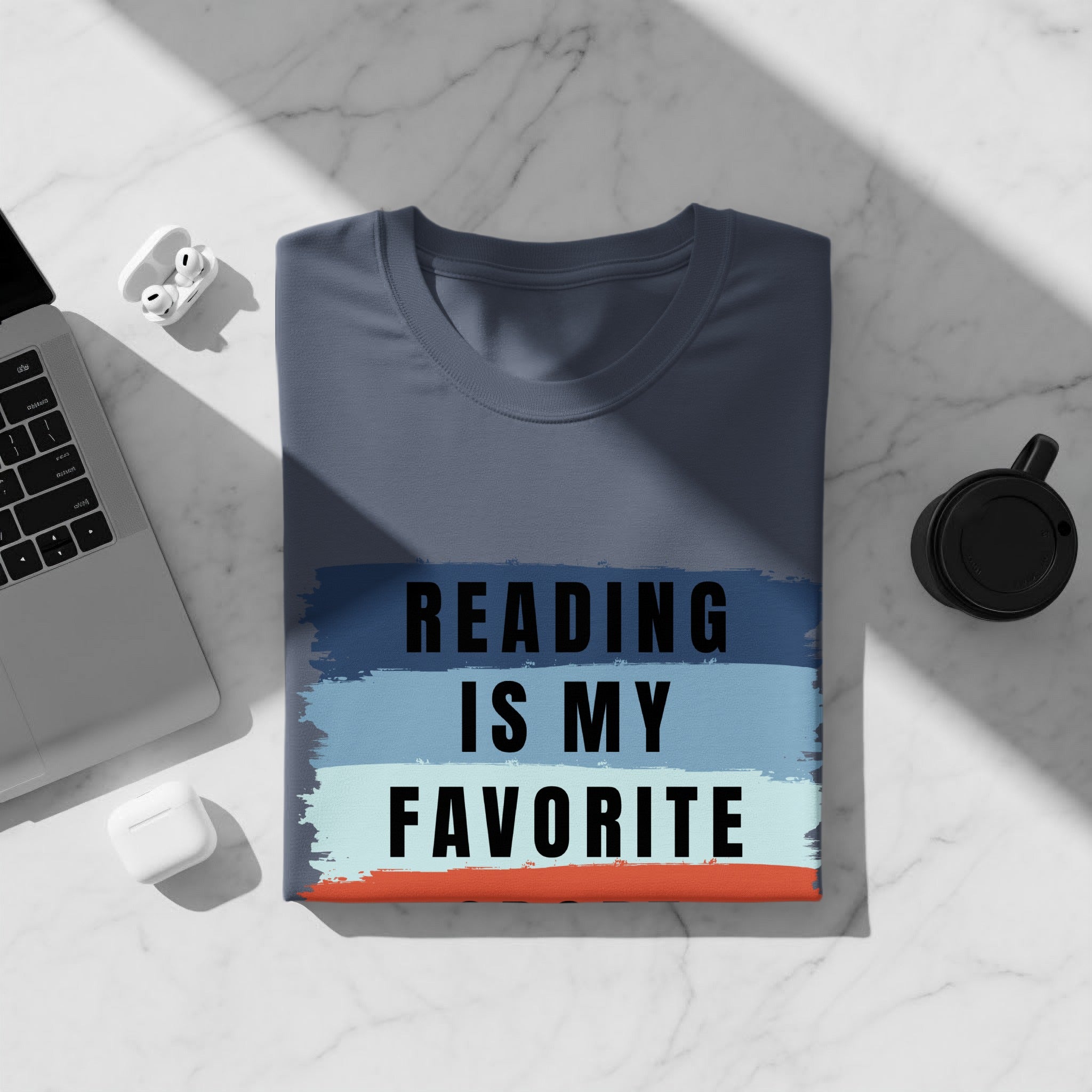 Dark gray t-shirt with navy, light blue, and orange horizontal stripes and black text reading "READING IS MY FAVORITE".