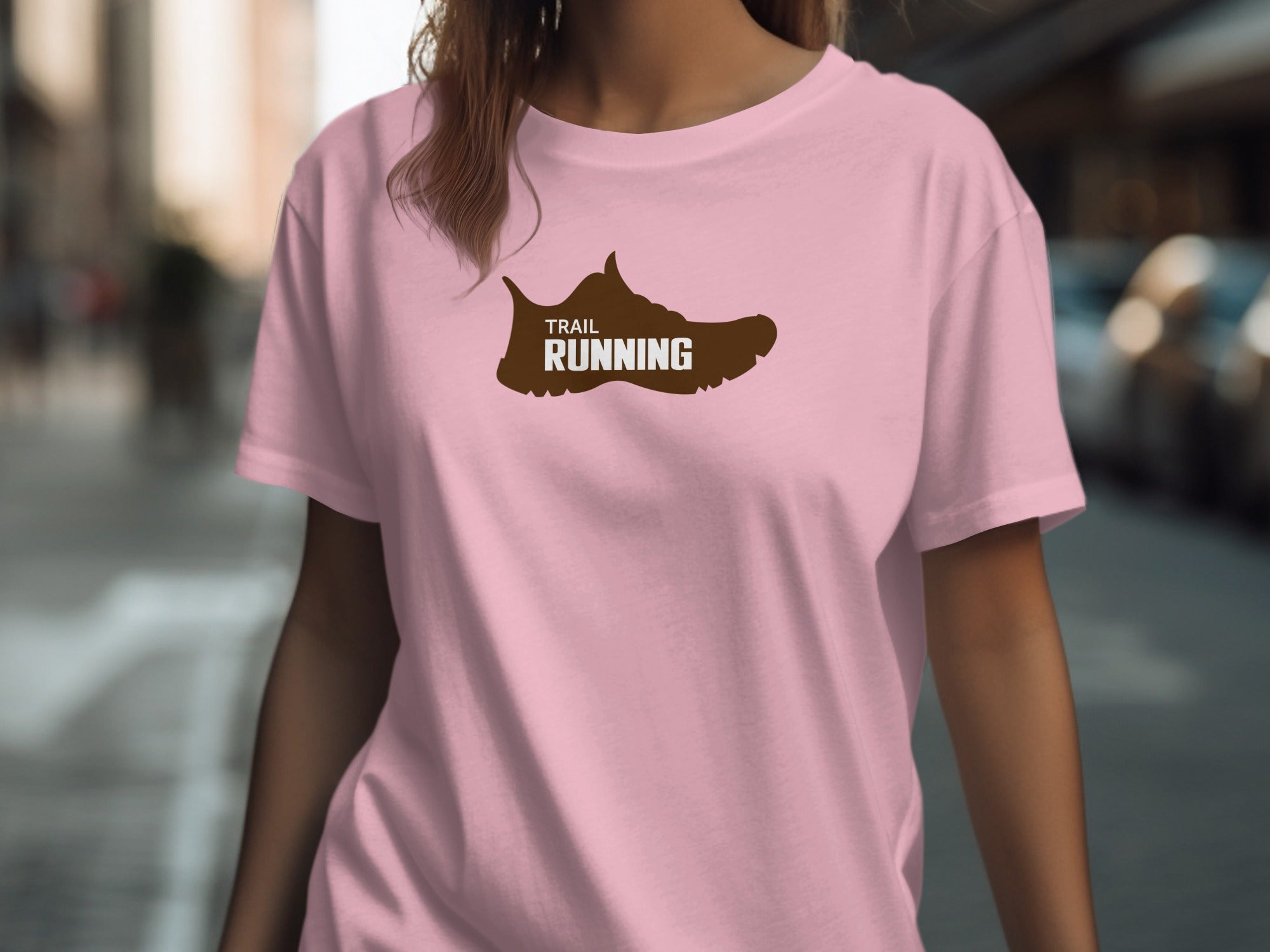 Pink t-shirt with brown trail running shoe graphic.