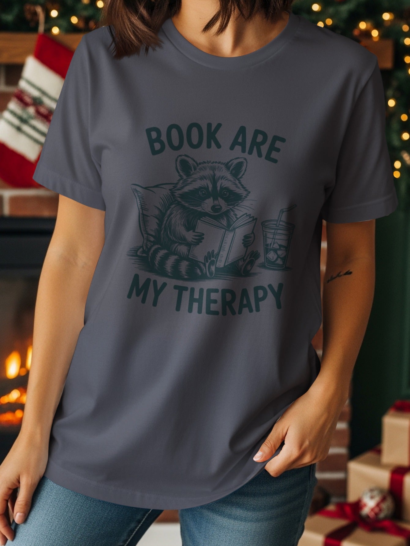Dark grey t-shirt with raccoon reading a book and text "BOOK ARE MY THERAPY".