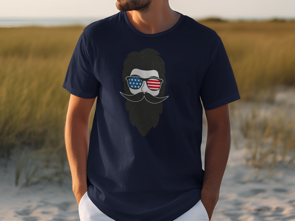 Navy t-shirt with graphic of bearded man wearing American flag sunglasses.