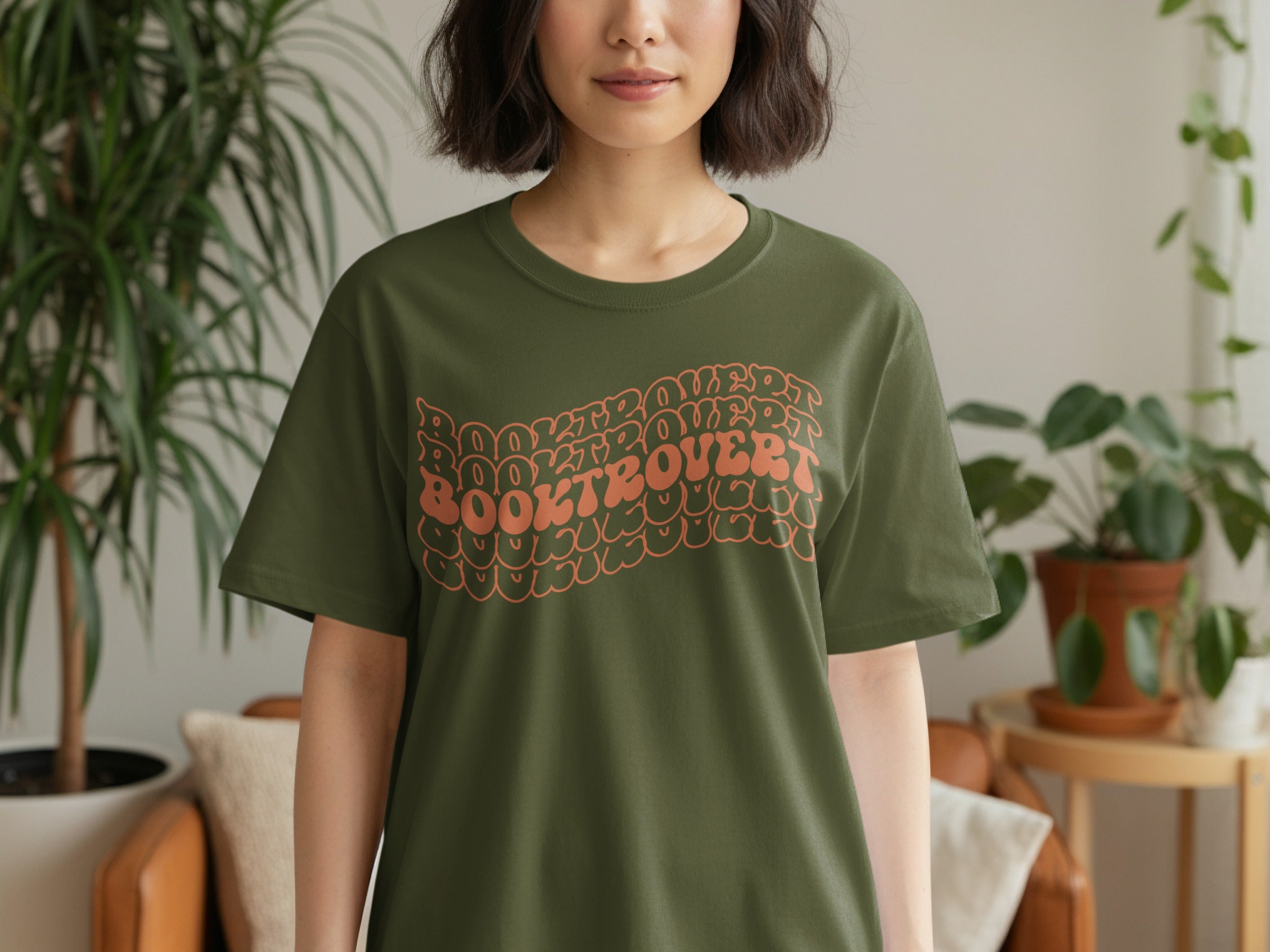 Olive green t-shirt with wavy "Booktrovert" text graphic.