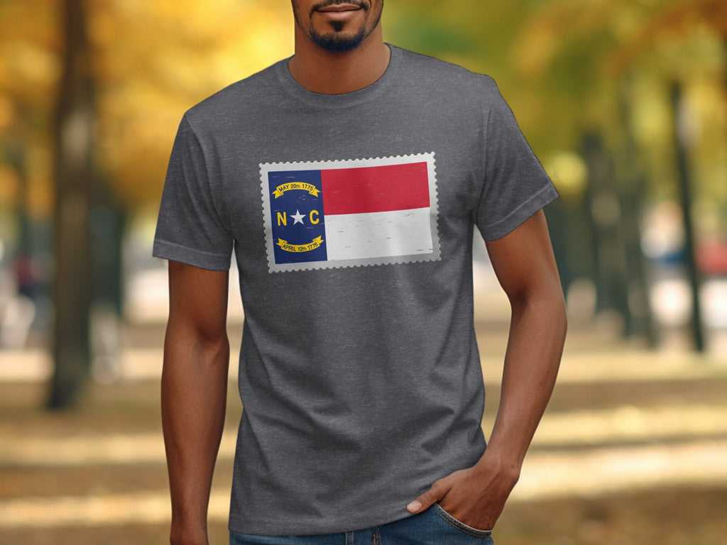 Gray t-shirt featuring a North Carolina flag design in a postage stamp shape.