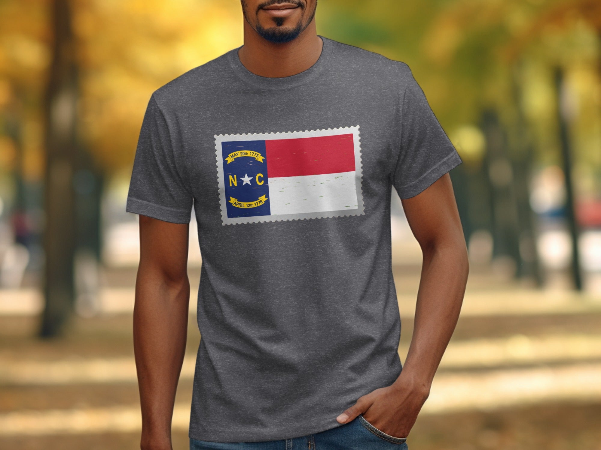 Gray t-shirt featuring a North Carolina flag design in a postage stamp shape.