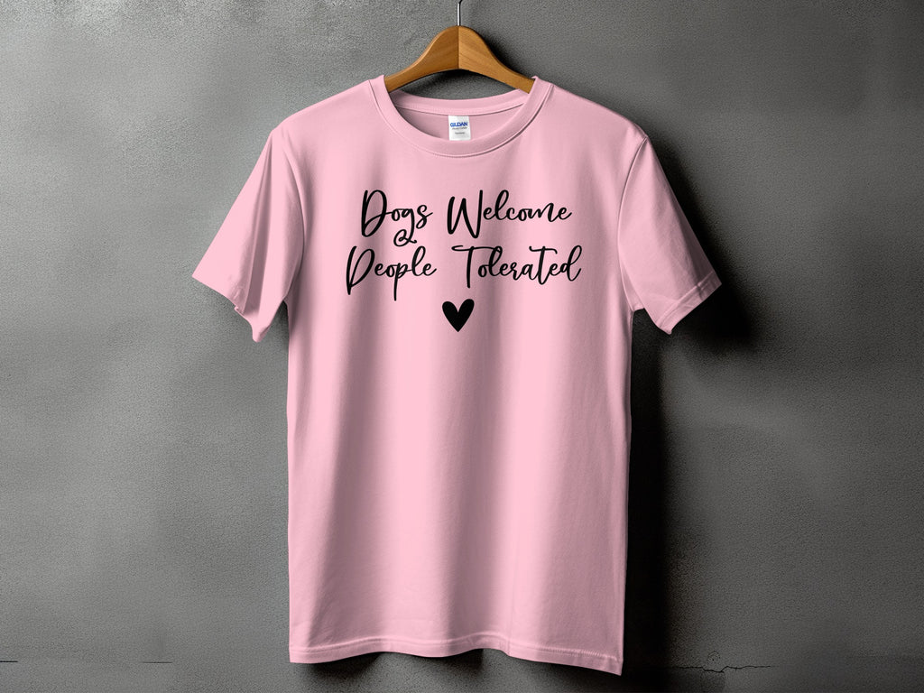 Pink t-shirt with "Dogs Welcome People Tolerated" text and a heart.