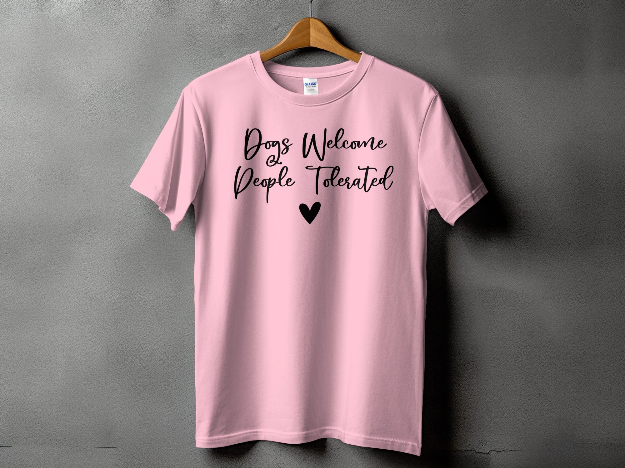 Pink t-shirt with "Dogs Welcome People Tolerated" text and a heart.