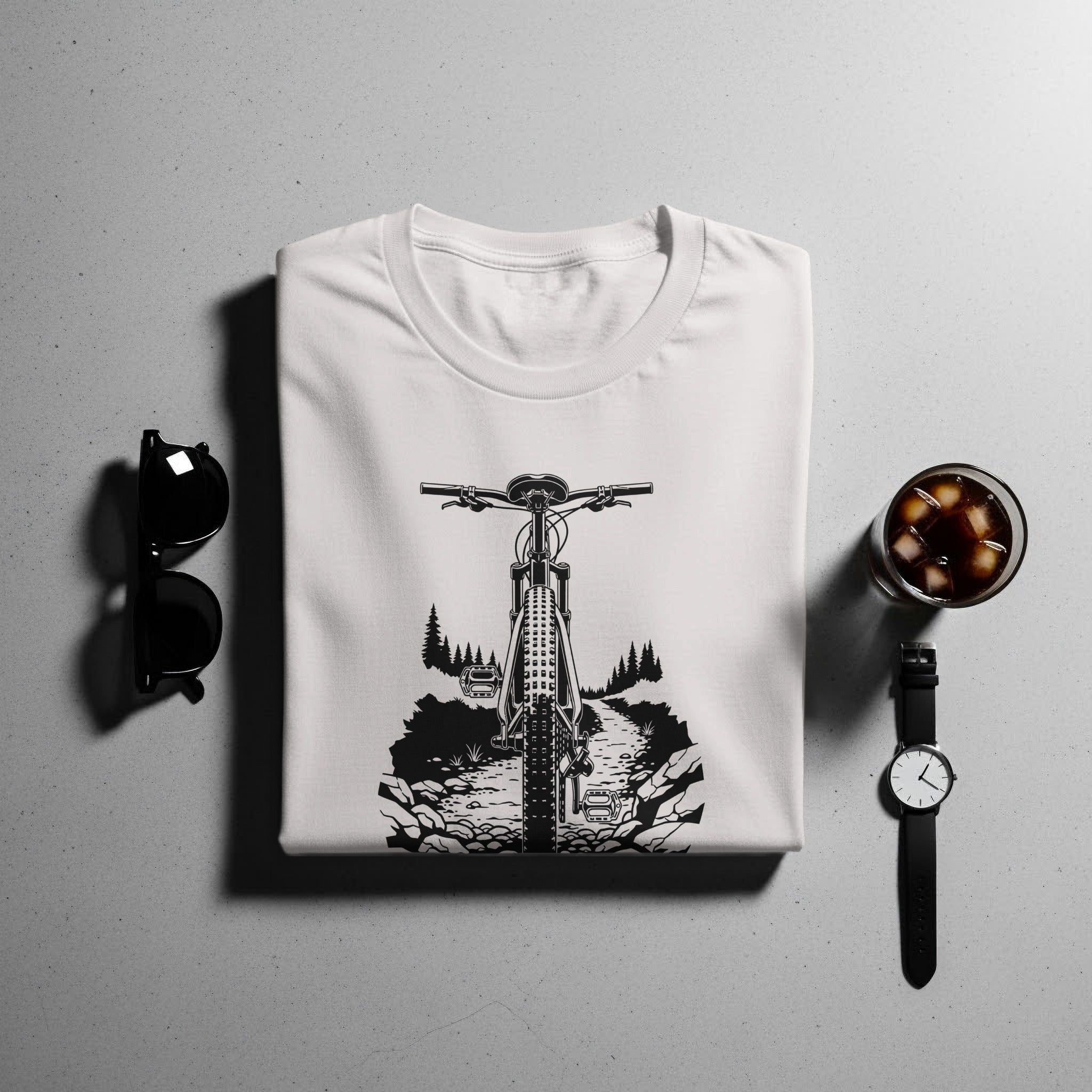 White t-shirt with a black graphic of a bicycle on a mountain trail.
