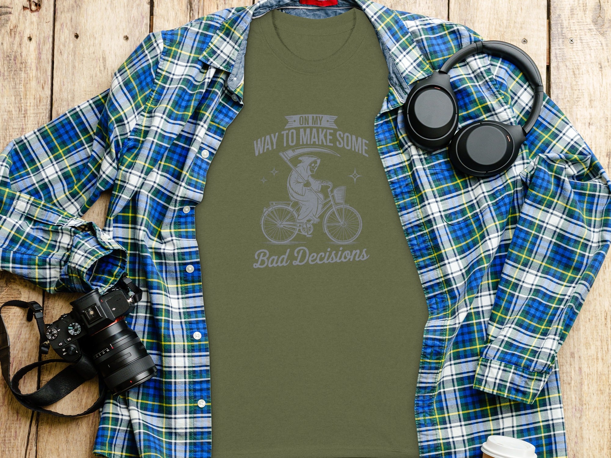 Green t-shirt with grim reaper on bicycle graphic and "Bad Decisions" text.