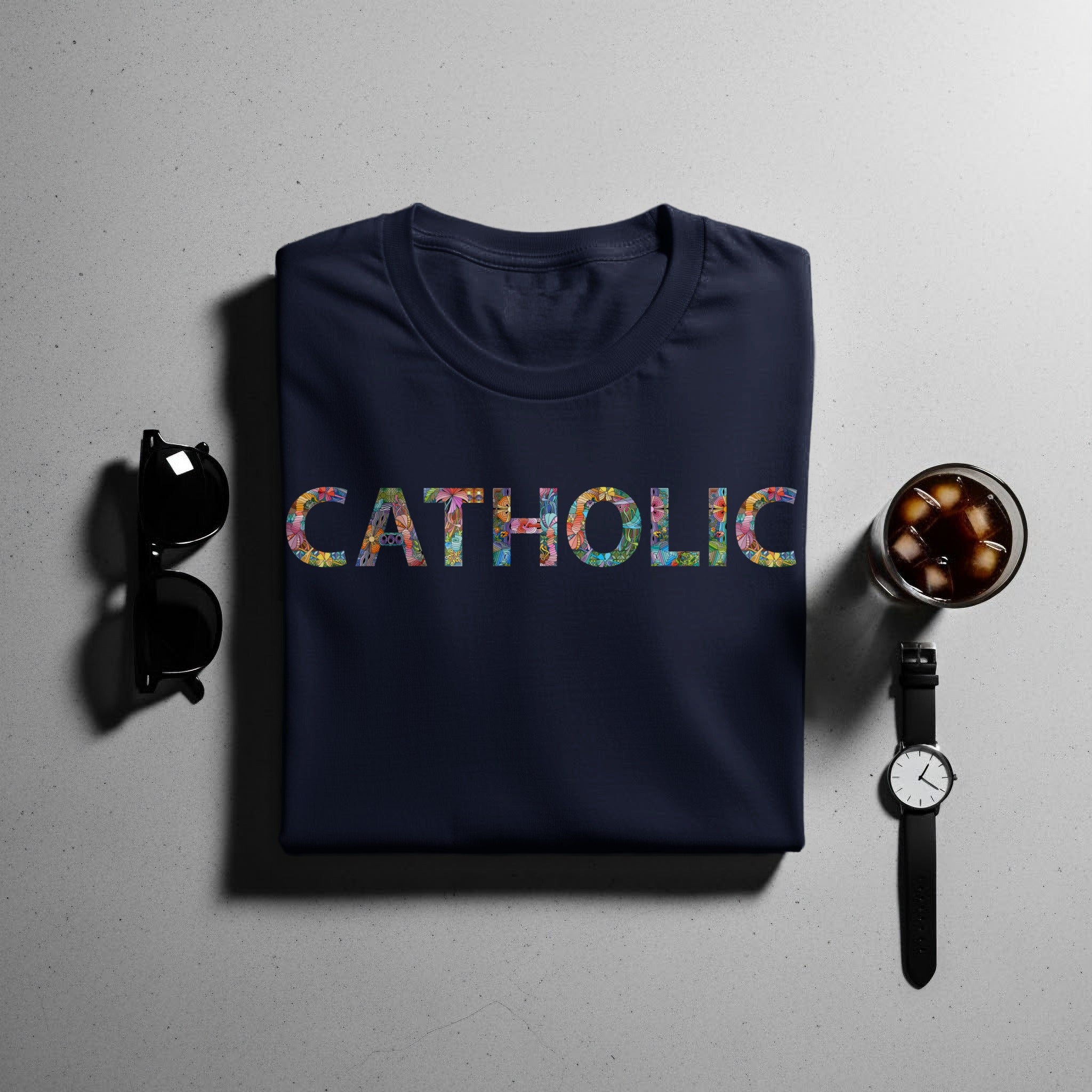 Navy t-shirt with colorful patterned text that reads "CATHOLIC".