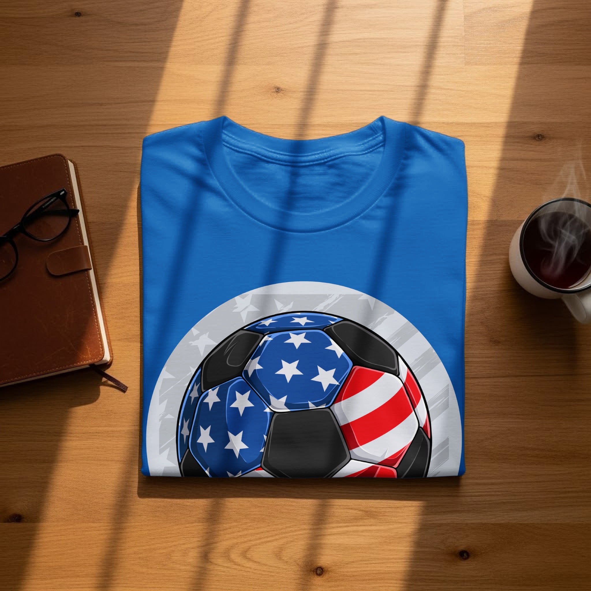 Blue t-shirt with a soccer ball design featuring the American flag.