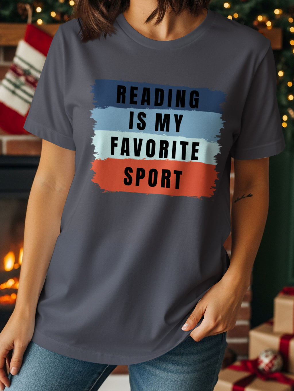 Gray t-shirt with "READING IS MY FAVORITE SPORT" text on colorful stripes.