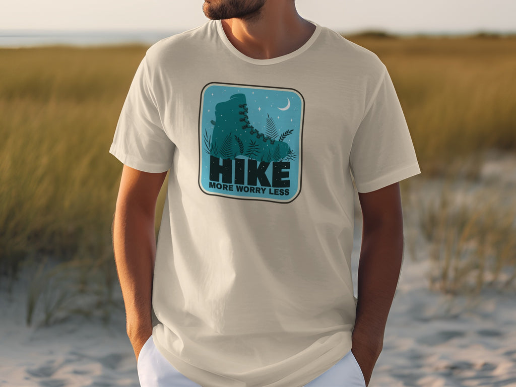 T-shirt with graphic of a hiking boot, plants, moon, and text "HIKE" and "MORE WORRY LESS".