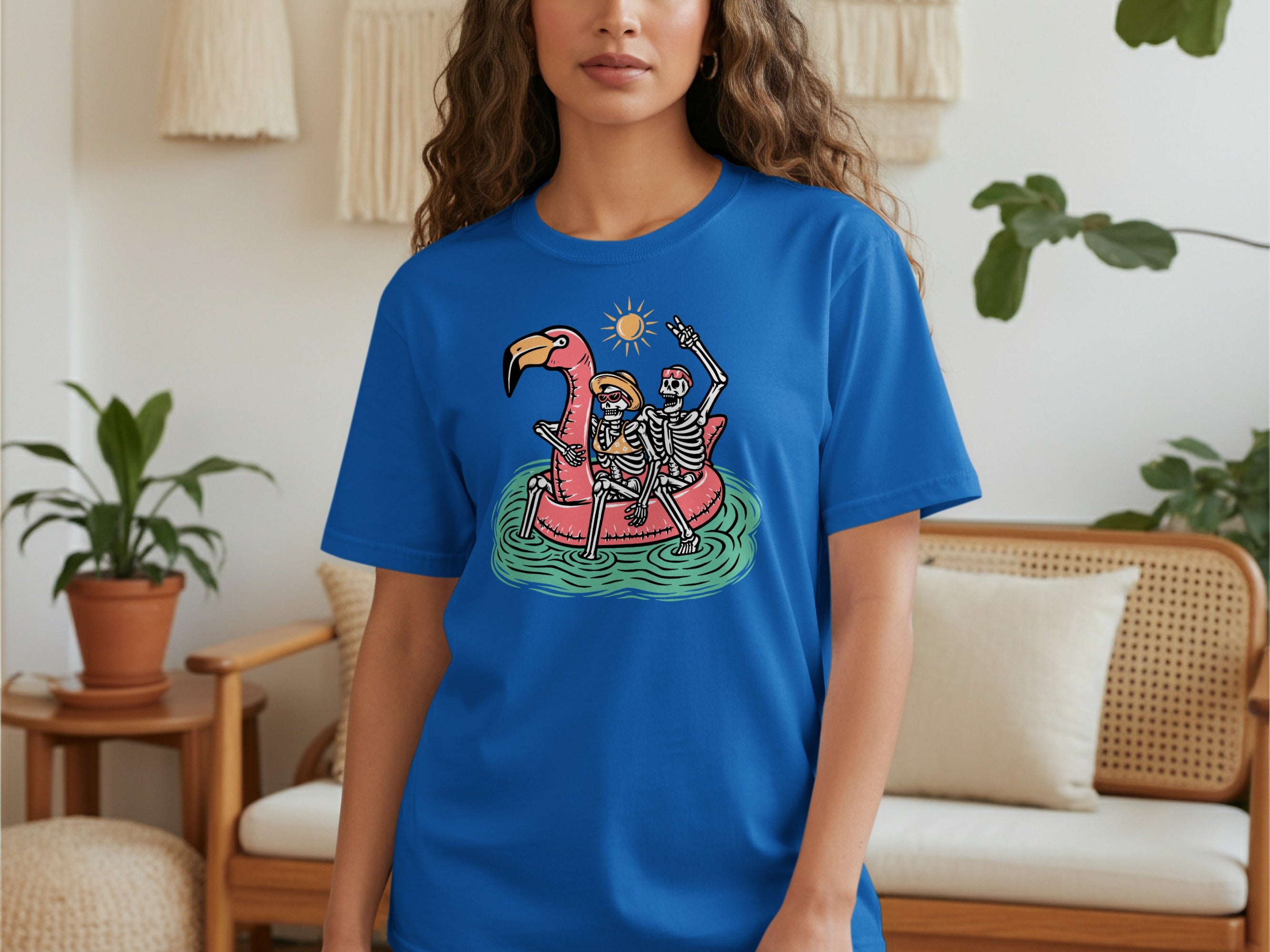 Two skeletons relax on a flamingo float under a sunny sky.