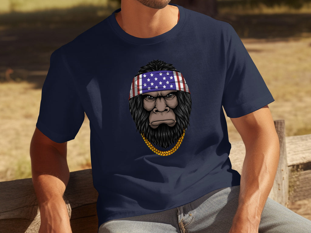 Bigfoot wearing an American flag bandana and gold chain on a navy t-shirt.