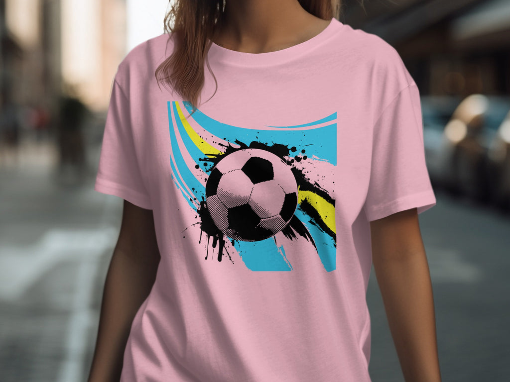 Pink t-shirt with black halftone soccer ball and abstract colorful paint splatters.