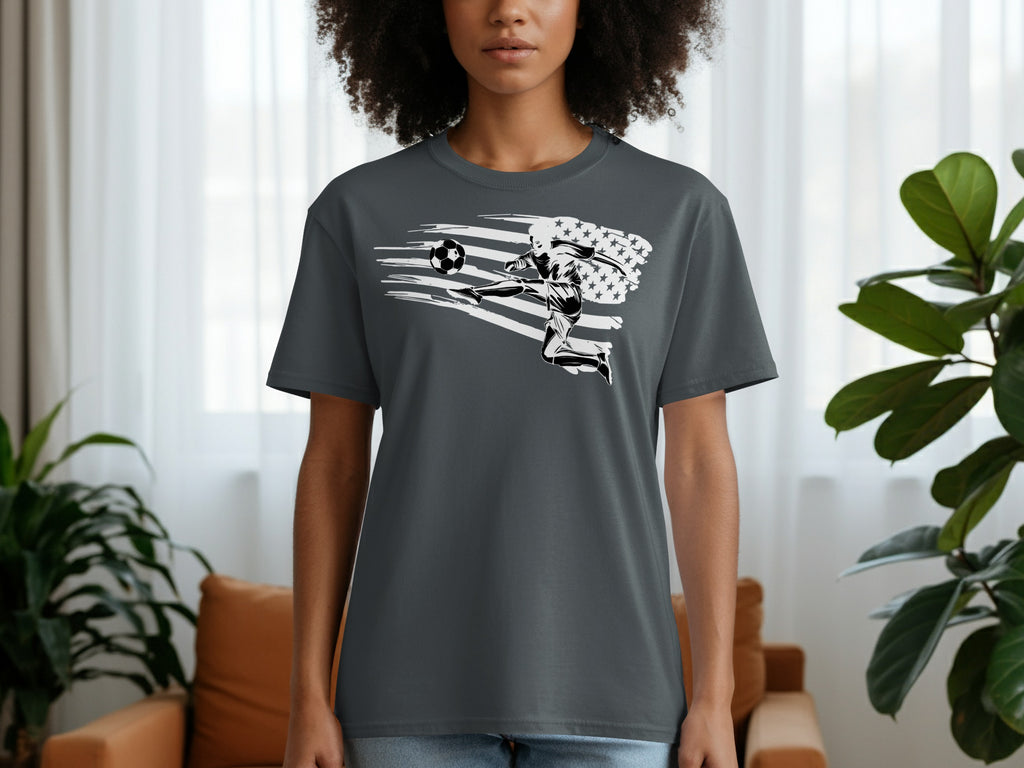 Dark grey t-shirt with a graphic of a soccer player kicking a ball with an American flag design.