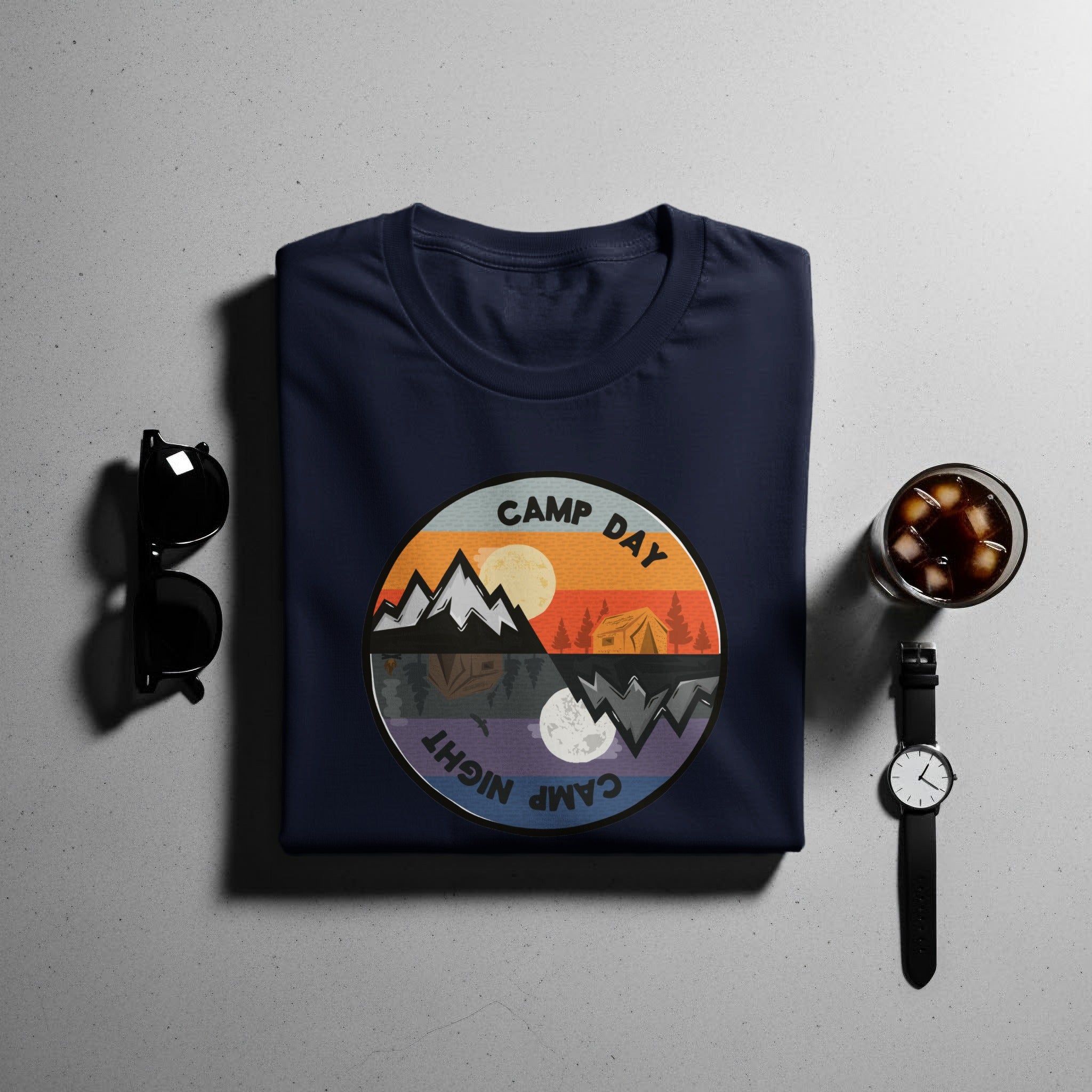 Navy t-shirt with a circular graphic depicting day and night camping scenes.
