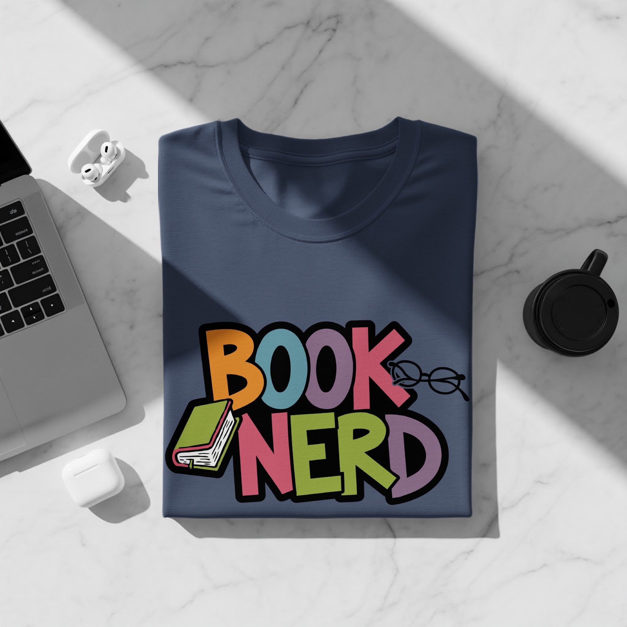 Navy t-shirt with colorful "BOOK NERD" text, book, and glasses graphic.