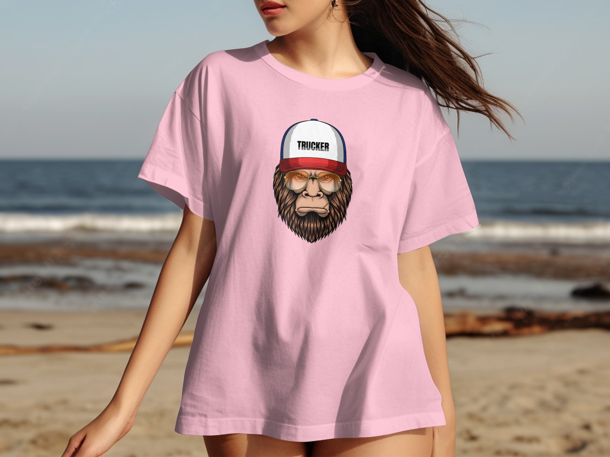 Pink t-shirt with graphic of a bearded creature wearing glasses and a "TRUCKER" hat.