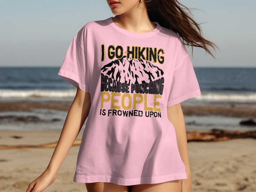 Pink t-shirt with "I GO HIKING BECAUSE PUNCHING PEOPLE IS FROWNED UPON" text.