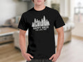 Black t-shirt with a graphic of a cabin, trees, hiker, and dog. Text reads: HAPPY HIKER LIVE, LOVE, HIKE.